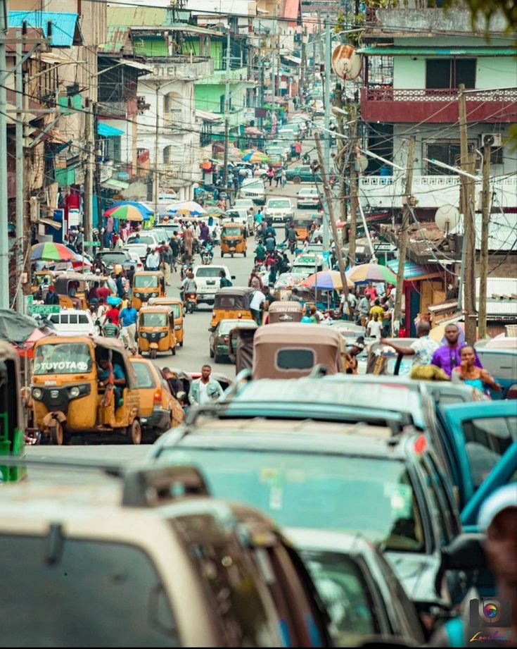 Busy street with taxis and tuk-tuks in Monrovia, Liberia